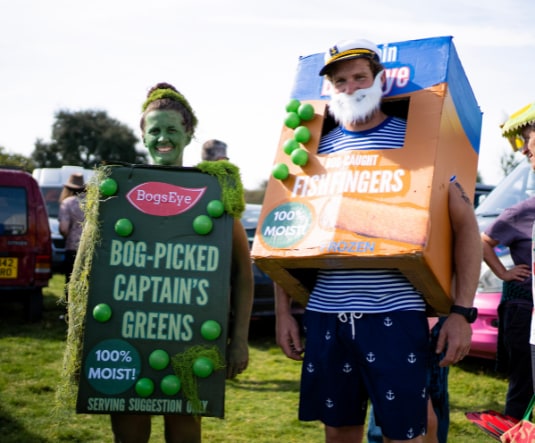 Two competitors in home-made fancy dress costumes at the bog site